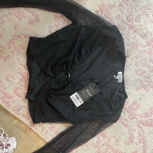 UK 12 so US 8 I believe black mesh sleeve top